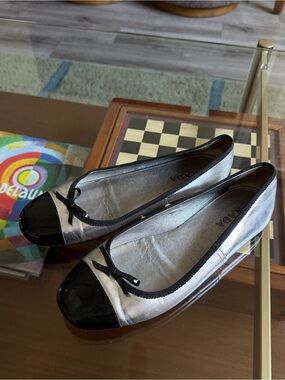 PRADA • metallic silver bow cap toe ballet flats